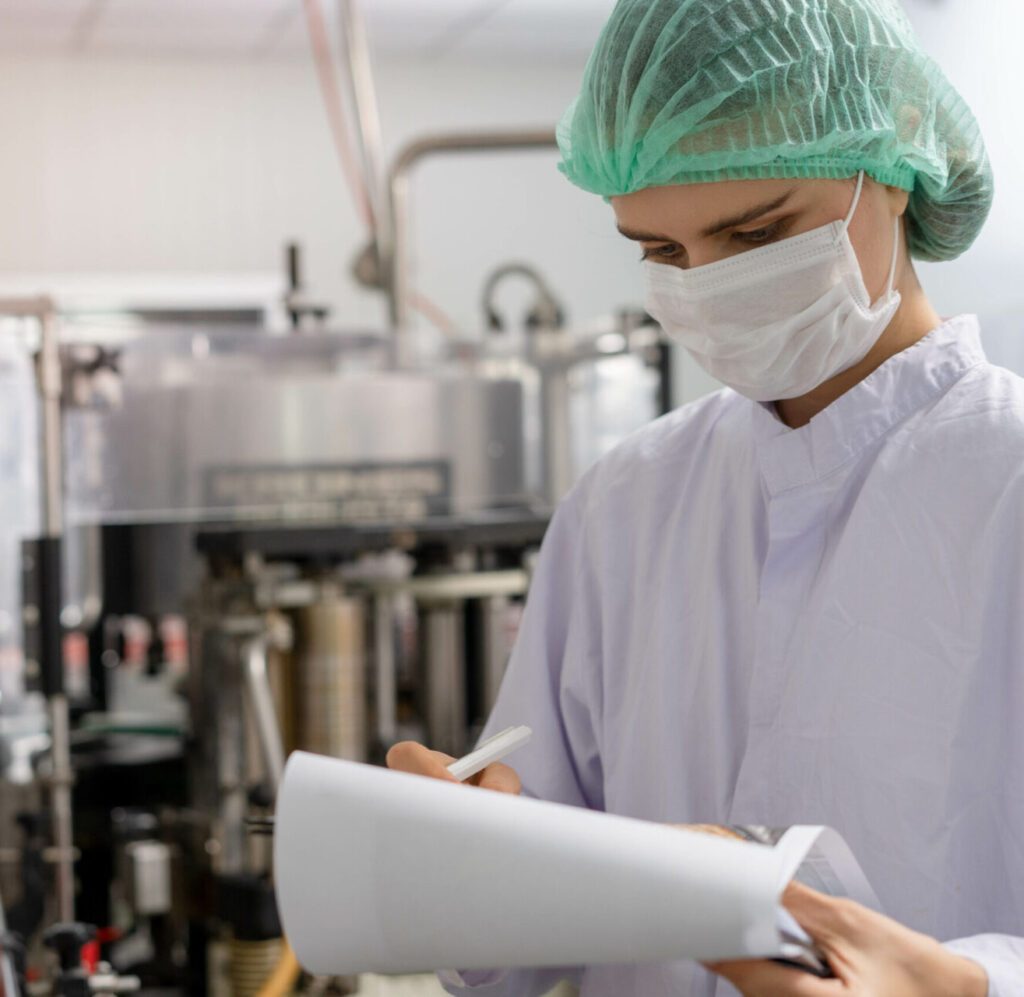 A tech expert or inspector is taking notes on the clipboard to v